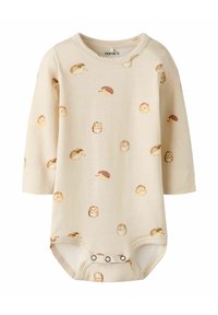 Body z długim rękawem w jasnobeżowej bawełnie z powtarzającym się nadrukiem jeża. Posiada zapięcie na napy na dole. Miękka, gładka struktura.