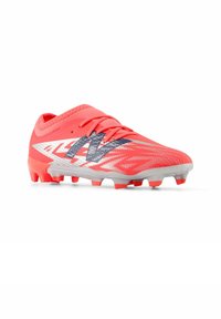 Bright coral soccer cleat with a textured surface, featuring a silver and navy design. Key details include molded studs and a low-cut silhouette.