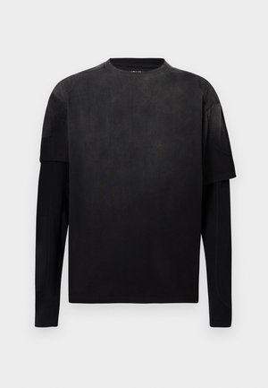 Black long-sleeve shirt with a smooth finish and contrasting texture on the shoulders. Crew neck and modern, boxy fit design.