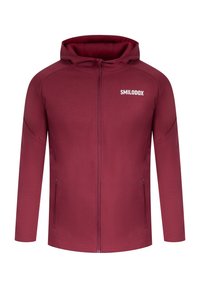 Sudadera con cremallera de color vino hecha de un tejido suave. Cuenta con una capucha, mangas largas y un logo en la parte superior izquierda del pecho. Dos bolsillos laterales.