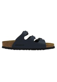 Black Birkenstock sandals with three adjustable straps, cork footbed, and textured rubber sole for grip; smooth synthetic upper material.