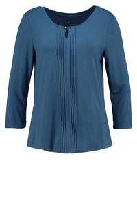 Halenka s třičtvrtinovými rukávy v tealm barvě, oválný výstřih, centrální sklady a malý knoflík u výstřihu.