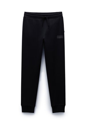 Pantalones de chándal negros de tela suave, con una cintura elástica con cordón, bolsillos laterales y puños acanalados.