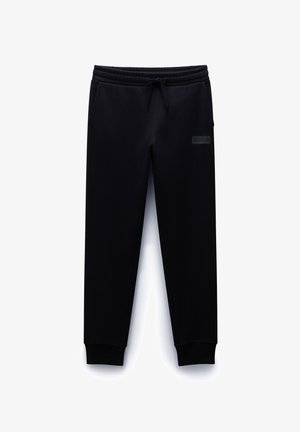 Schwarze Sweatpants aus weichem Material, mit elastischem Bund und Kordelzug, seitlichen Taschen und gerippten Säumen.