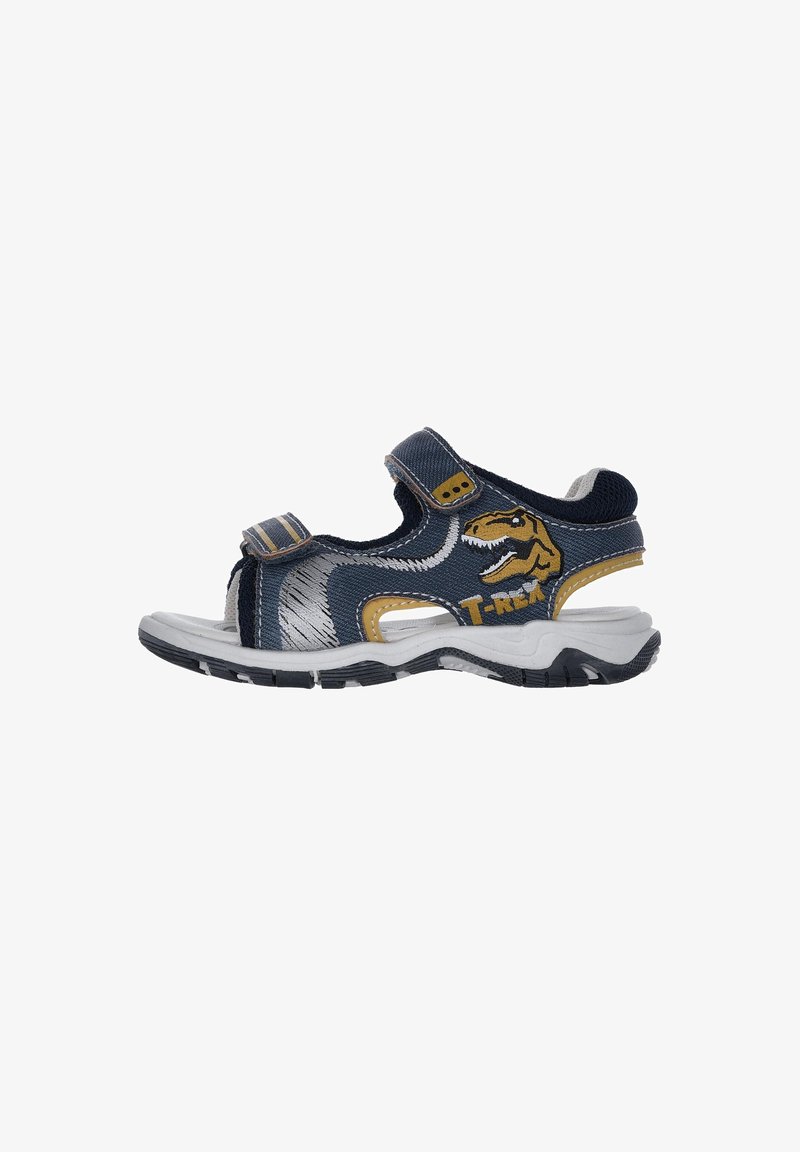 Sandalias infantiles de tela azul marino con acentos amarillos, con un diseño de T-Rex, tiras de Velcro y una suela de goma blanca.