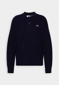 Navy long-sleeve knitted polo shirt with two buttons, featuring a green Lacoste crocodile logo on the left chest, ribbed cuffs and hem.