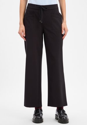 Black wide-leg trousers with front patch pockets and drawstring waist worn with black loafers and dark socks on a standing person.