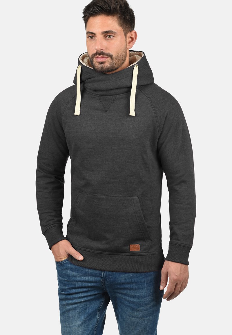 Sudadera gris oscuro con un suave cuello forrado en beige, bolsillo canguro frontal y puños acanalados. Presenta un parche de cuero de la marca en el dobladillo inferior.