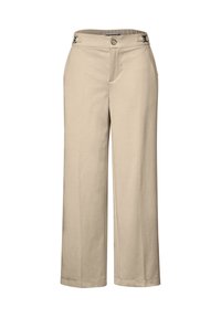 Beige leveled pants made of soft fabric, featuring a button closure, side accents, and a smooth texture.