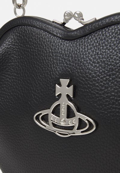 Black textured leather handbag featuring a silver metal logo with rounded details and a clasp closure at the top with decorative accents.