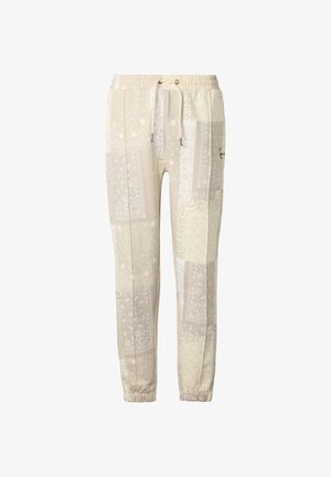 Pantalon de jogging beige clair avec imprimé patchwork paisley, taille élastique avec cordon de serrage et poignets élastiques aux chevilles.