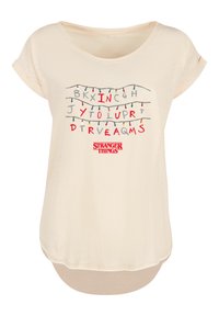 Light beige short-sleeve t-shirt featuring graphic text resembling an alphabet with Christmas lights; "Stranger Things" logo at the bottom.
