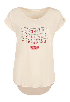 Light beige short-sleeve t-shirt featuring graphic text resembling an alphabet with Christmas lights; "Stranger Things" logo at the bottom.