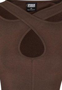 Brown tank top featuring a cut-out detail and crisscross design at the neckline. Made from a stretchy fabric. Label reads "Urban Classics, XS."