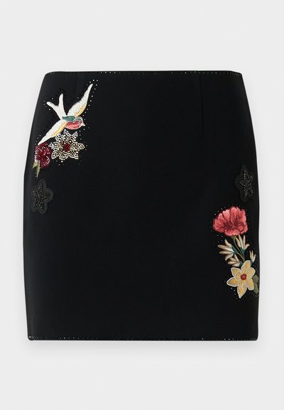 Black mini skirt with embroidered bird, red and yellow flowers, and small black star appliqués on front sides.