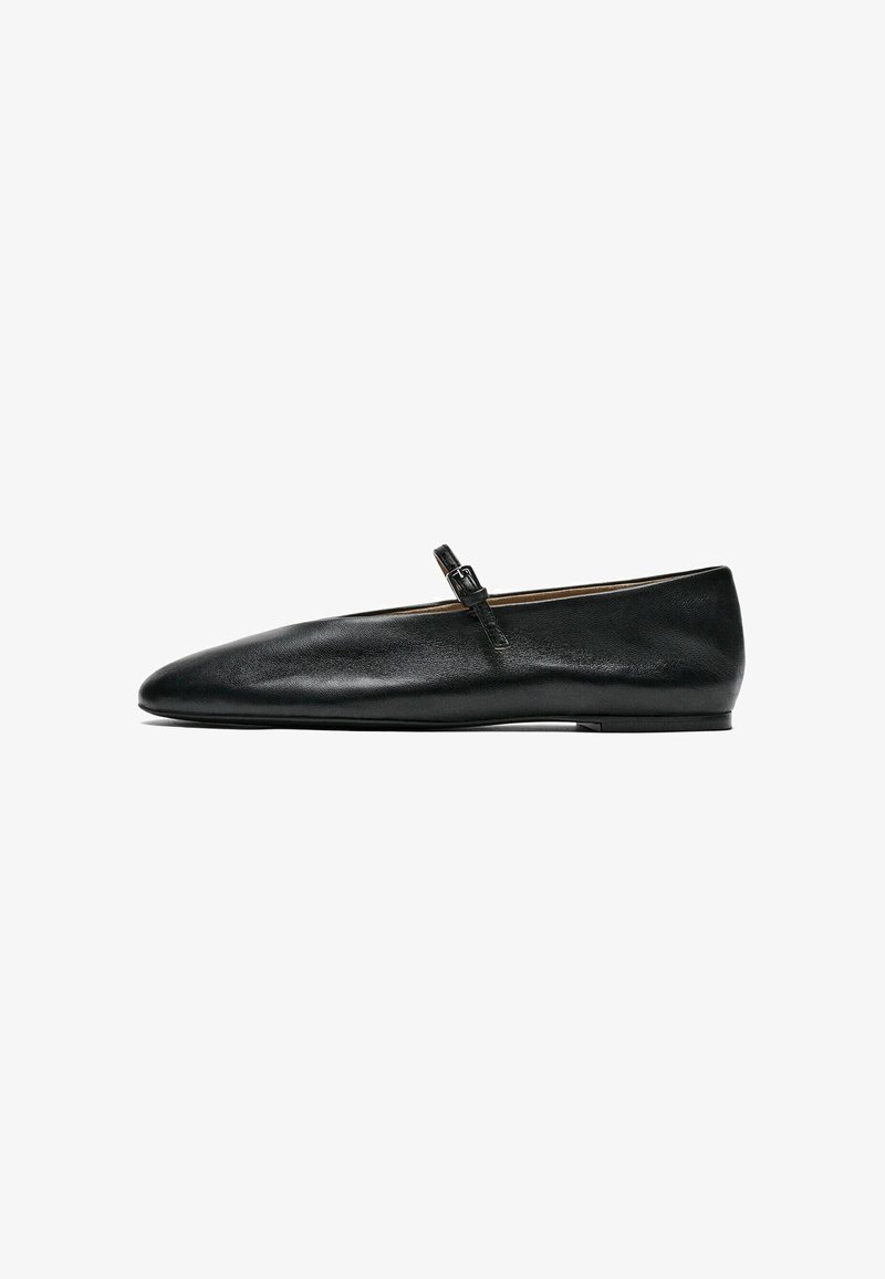 Black flat leather Mary Jane shoe with a thin strap and buckle across the instep, shown in side profile on a white background.