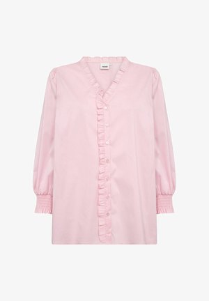 Svetloružová blúzka s výstrihom do V, zapínaním na gombíky vpredu a volánikovým lemovaním. Má dlhé nafúknuté rukávy so stiahnutými manžetami. Vyrobená z bavlnenej tkaniny.