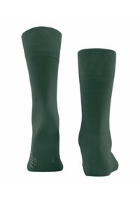 Calcetines verdes hasta la rodilla con un puño acanalado, fabricados en una tela suave. Incluyen un dedo del pie sin costuras y un talón reforzado para mayor durabilidad.