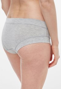 Shorts en coton gris pour garçons, présentant une texture douce et lisse, une taille élastique et sans coutures visibles pour un look sans couture.