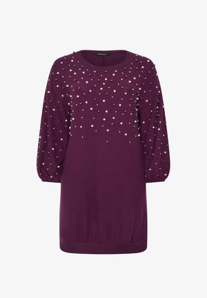 Purple knit dress with long, puffed sleeves. Decorated with metallic studs in varying sizes across the front. Ribbed hem and cuffs.