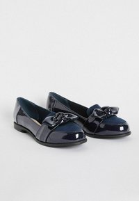 Ballerine in pelle lucida blu navy con un dettaglio in fiocco testurizzato sulla punta. Forma a punta arrotondata, tacco basso e accenti in suede blu navy a contrasto.