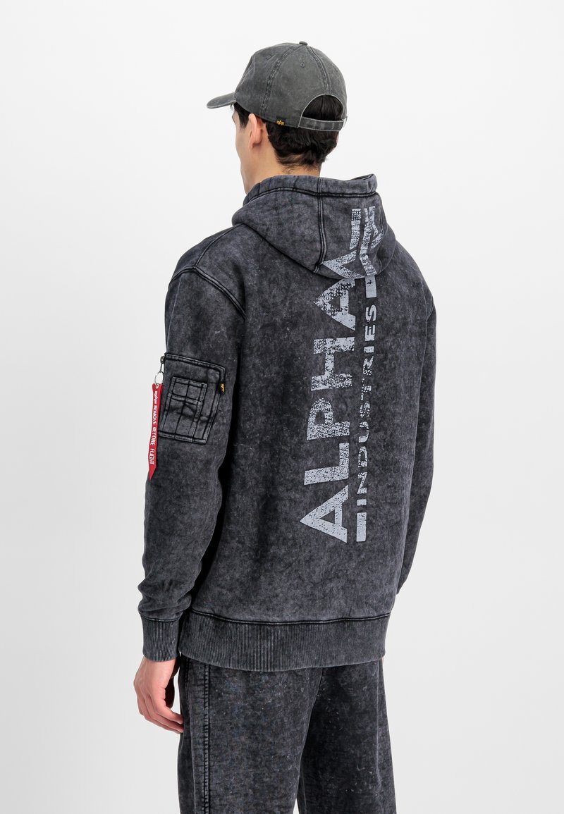 Dark gray hooded sweatshirt with a distressed texture, "ALPHA" branding, and a red zippered pocket detail on the left arm.