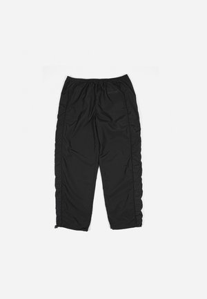 Black athletic pants with an elastic waistband, featuring side panels with a grid pattern and zippers at the ankles. Smooth, lightweight fabric.