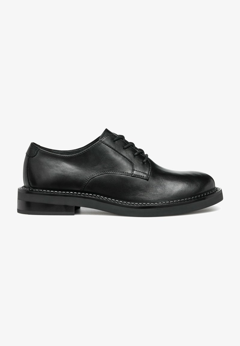 Chaussures habillées en cuir noir avec un bout arrondi, design à lacets et texture lisse. Dotées d'un petit talon et d'un détail de couture contrastant.
