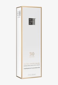 Hvit, rektangulær boks med gullakenter. Forsiden viser produktnavnet "Ultra Shine Mask" og inneholder detaljert informasjon om ingrediensene. Størrelse: 200 ml.