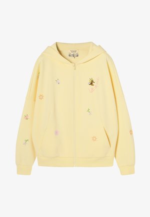 Jasnożółta bluza z kapturem na zamek, ozdobiona małymi pastelowymi kwiatami, grafiką pszczoły oraz napisem "let it bee" po prawej stronie z przodu.