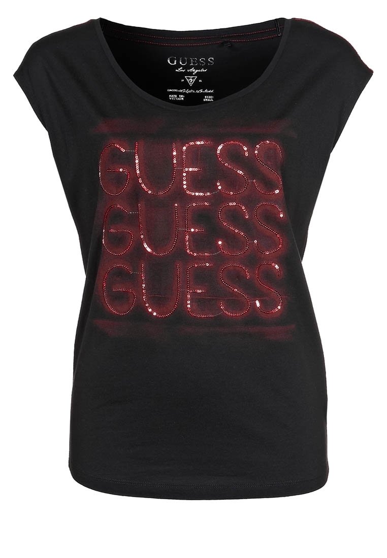 Sort kortærmet t-shirt med skinnende røde palietter, der stavrer "GUESS" flere gange. Blødt stof, rund halsudskæring og afslappet pasform.