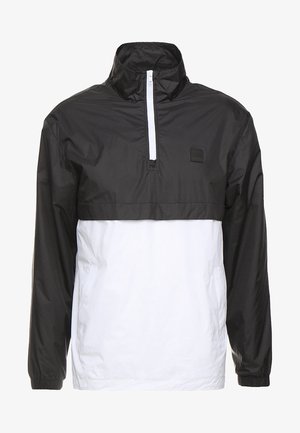 Fekete-fehér pulóverdzseki negyed zipzárral, magas gallérral és rugalmas mandzsettákkal. Könnyű, vízálló anyagból készült.