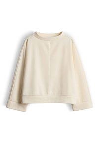 Roomkleurige cropped sweatshirt met een ronde hals, doorlopende schouders en brede manchetten. Soepele textuur met verticale naaddetails.