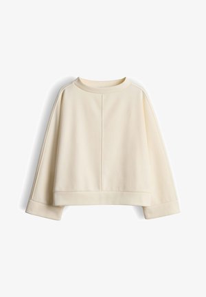 Roomkleurige cropped sweatshirt met een ronde hals, doorlopende schouders en brede manchetten. Soepele textuur met verticale naaddetails.