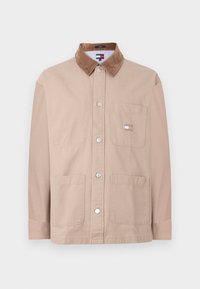 Beige button-up jacket with brown corduroy collar, chest pocket with Tommy Jeans logo, and two lower front pockets.