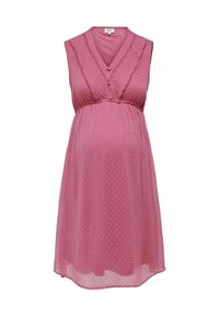 Robe de maternité rose sans manches avec col en V, tissu texturé à pois, taille empire froncée et détail de bordure délicate sur le corsage.