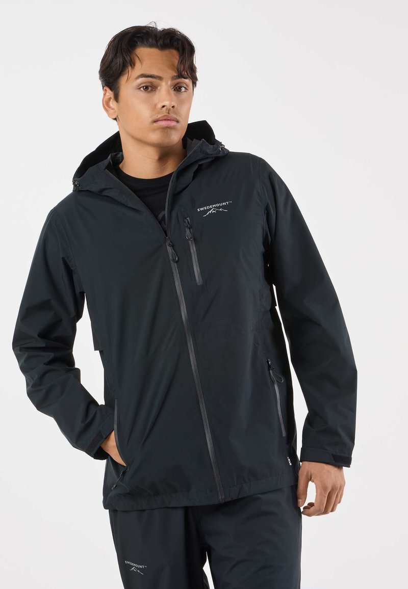 Black waterproof jacket with a hood, front zip closure, and two zippered pockets. Features a logo on the chest and smooth, matte texture.