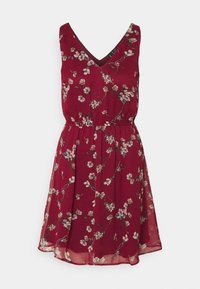 Robe bordeaux avec un décolleté en V, motif floral crème et rose, taille élastique, jupe fluide et tissu léger.