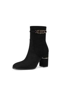 Stivale alla caviglia in suede nero con punta squadrata e tacco a blocco di altezza media. Presenta un dettaglio a striscia dorata con logo intorno alla caviglia.