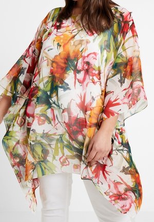 Løs, gennemsigtig top med brede ærmer med et levende blomsterakvarelmønster i røde, orange, gule, grønne og pink toner.