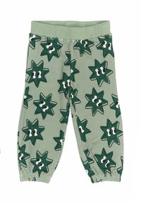 Pantaloni jogger din bumbac verde, cu modele în formă de stea și ochi. Au un brâu elastic și manșete strânse la gleznă.