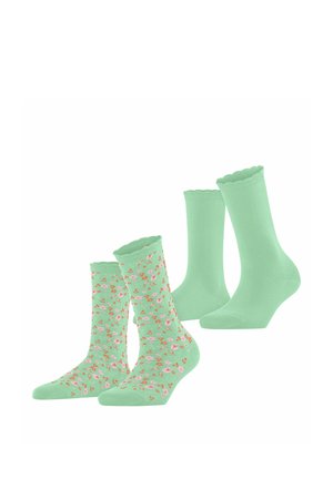 Due paia di calzini verde menta a metà polpaccio, uno tinta unita con bordi smerlati, l'altro con un piccolo motivo floreale rosa e arancione.
