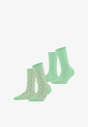 Twee paar muntgroene sokken tot halverwege de kuit, één effen met geschulpte randen, de ander met een klein roze en oranje bloemenpatroon.