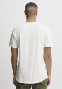 Hvid bomulds T-shirt med korte ærmer og rund halsudskæring, med lige pasform og et lille logoetiket i bunden.