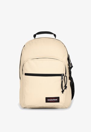 Beige polyester backpack with a front zip pocket, black zippers, mesh side pocket, and a top handle. Features Eastpak logo on the front.