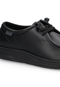 Schwarze Lederturnschuhe mit dickem Sohlenverband, elastischen Zugbändern und einem kleinen "LIU·JO"-Stoffetikett an der Seite.