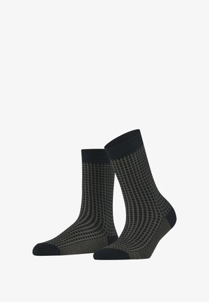 Grüne und schwarze Socken mit Muster, die ein Rautendesign aufweisen, mit gerippten Bündchen, verstärkter Zehenpartie und glatter Textur. Mittlere Wadenlänge.