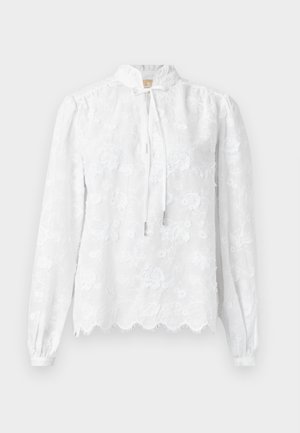 Λευκό δαντελένιο μπλουζάκι με μακριά μανίκια, κεντήματα με λουλούδια, κυματιστό τελείωμα, ψηλό γιακά και κλείσιμο με δέσιμο μπροστά.