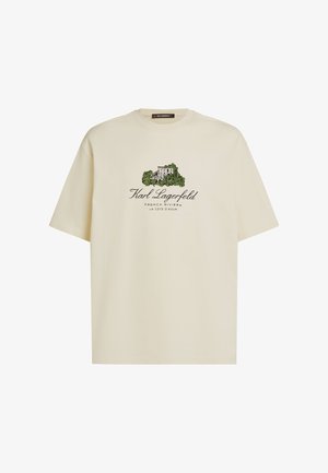 Cremefarbenes Baumwoll-T-Shirt mit einem Grafikdruck eines Hauses und Laub sowie den Schriftzügen "Karl Lagerfeld", "French Riviera" und "La Cote D'Azur".