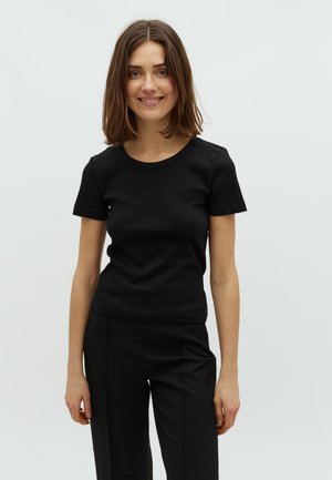 Black fitted t-shirt with short sleeves, ribbed texture, and a round neckline, styled with high-waisted black pants.